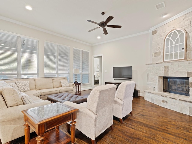 897 Clear Water Dr, Allen, TX 75013 - living area with dark wood-style flooring, crown molding, a ceiling fan, a stone fireplace, and recessed lighting