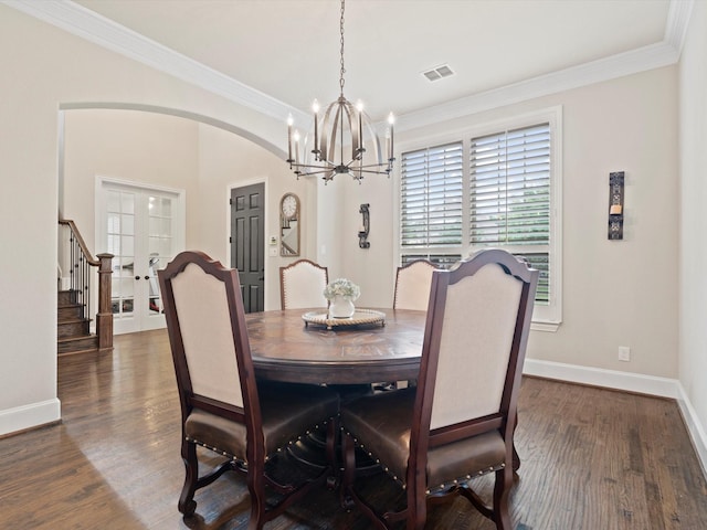 897 Clear Water Dr, Allen, TX 75013 - dining room with a chandelier, arched walkways, ornamental molding, baseboards, and dark wood-type flooring