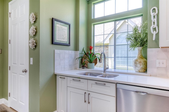 10108 Hunter Run, Frisco, TX 75035 - kitchen featuring dishwasher, light countertops, white cabinetry, a textured wall, and backsplash