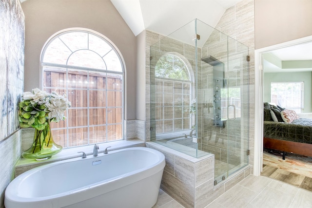 10108 Hunter Run, Frisco, TX 75035 - ensuite bathroom with vaulted ceiling, a soaking tub, a shower stall, and plenty of natural light