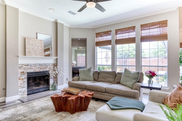 10108 Hunter Run, Frisco, TX 75035 - living room with crown molding, ceiling fan, wood finished floors, and a fireplace