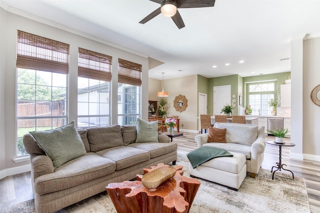 10108 Hunter Run, Frisco, TX 75035 - living area featuring recessed lighting, a ceiling fan, light wood-style flooring, and crown molding