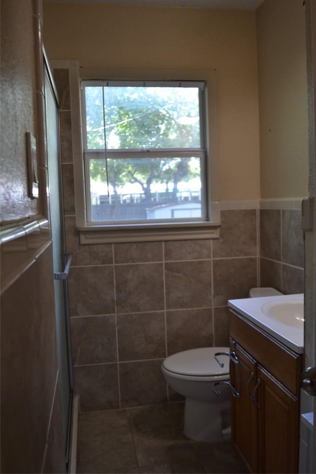 202 Pine St, Arlington, TX 76011 - full bath with vanity, a shower stall, tile walls, toilet, and tile patterned floors