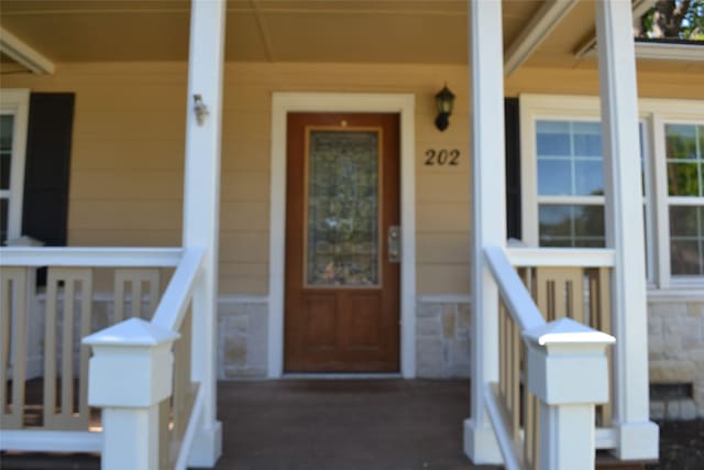 202 Pine St, Arlington, TX 76011 - property entrance featuring stone siding and a porch
