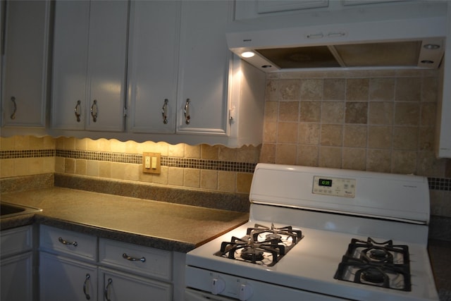 202 Pine St, Arlington, TX 76011 - kitchen with white range with gas stovetop, under cabinet range hood, and backsplash