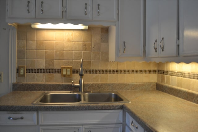 202 Pine St, Arlington, TX 76011 - kitchen with a sink, decorative backsplash, and white cabinets