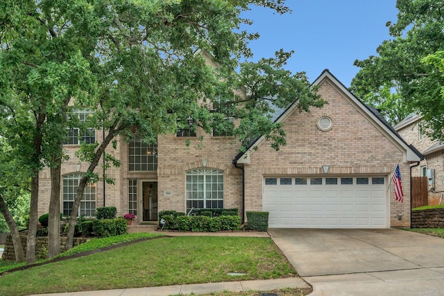 3916 Navajo Ln, Bedford, TX 76021 - view of front facade with concrete driveway, brick siding, a front lawn, and a garage