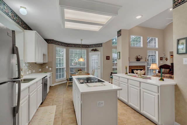 3916 Navajo Ln, Bedford, TX 76021 - kitchen with appliances with stainless steel finishes, a kitchen island, healthy amount of natural light, and white cabinetry