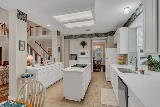 3916 Navajo Ln, Bedford, TX 76021 - kitchen with a sink, white appliances, tasteful backsplash, light countertops, and white cabinets