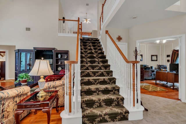 3916 Navajo Ln, Bedford, TX 76021 - staircase with a ceiling fan, a towering ceiling, and wood finished floors