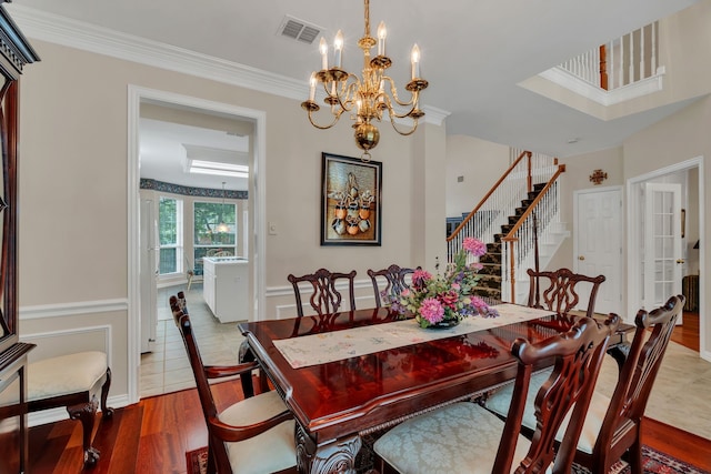 3916 Navajo Ln, Bedford, TX 76021 - dining room featuring stairway, a chandelier, ornamental molding, and wood finished floors
