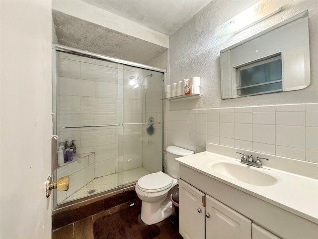 2725 Rustown Dr, Mesquite, TX 75150 - full bath featuring toilet, a shower stall, a textured wall, tile walls, and vanity