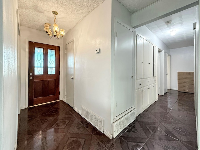 2725 Rustown Dr, Mesquite, TX 75150 - foyer entrance featuring a chandelier, a textured ceiling, and baseboards