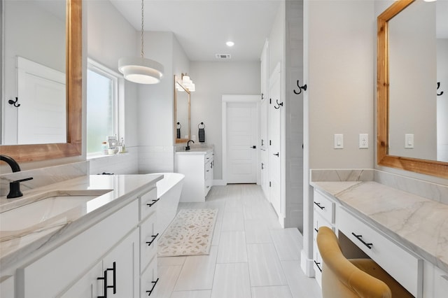 304 Red Roan Rdg, Weatherford, TX 76087 - bathroom featuring two vanities, recessed lighting, a soaking tub, and tile patterned floors