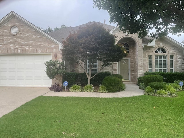 6506 Parkside Dr, Arlington, TX 76001 - view of front of house with brick siding, a front lawn, concrete driveway, and an attached garage