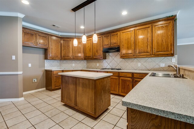 6506 Parkside Dr, Arlington, TX 76001 - kitchen with under cabinet range hood, brown cabinets, light countertops, decorative backsplash, and recessed lighting