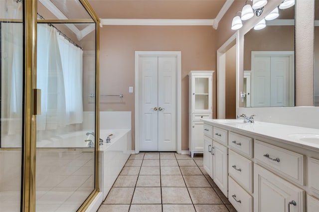 6506 Parkside Dr, Arlington, TX 76001 - full bath with crown molding, a shower stall, double vanity, a garden tub, and tile patterned flooring