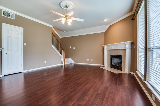 6506 Parkside Dr, Arlington, TX 76001 - unfurnished living room with a tiled fireplace, stairway, a ceiling fan, ornamental molding, and wood finished floors