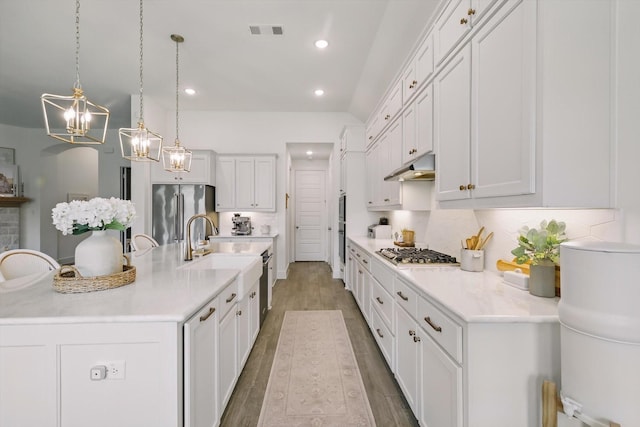 1809 Lithgow Rd, Celina, TX 75009 - kitchen featuring appliances with stainless steel finishes, under cabinet range hood, white cabinetry, and recessed lighting