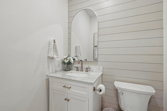 1809 Lithgow Rd, Celina, TX 75009 - half bath featuring vanity, toilet, and wood walls
