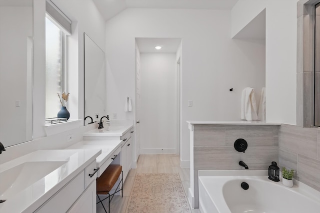 1809 Lithgow Rd, Celina, TX 75009 - bathroom featuring double vanity, a bath, and vaulted ceiling