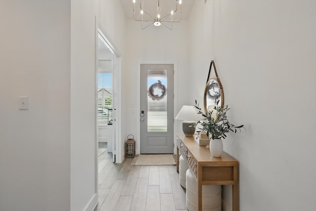 1809 Lithgow Rd, Celina, TX 75009 - foyer entrance with a chandelier, baseboards, light wood-style floors, and a towering ceiling