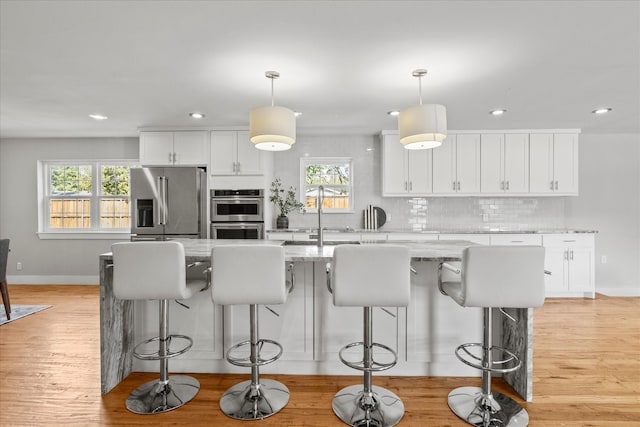 1705 Provincetown Ln, Richardson, TX 75080 - kitchen with stainless steel appliances, a sink, white cabinetry, light wood-style flooring, and recessed lighting
