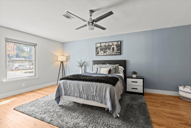 1705 Provincetown Ln, Richardson, TX 75080 - bedroom with baseboards, wood finished floors, and a ceiling fan