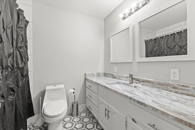 1705 Provincetown Ln, Richardson, TX 75080 - bathroom with toilet, vanity, baseboards, tile patterned flooring, and curtained shower