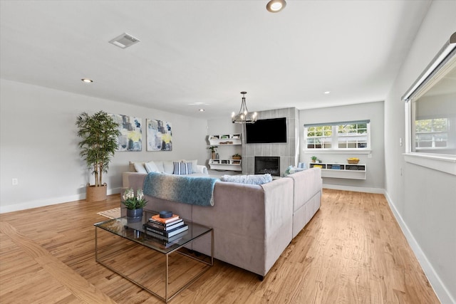 1705 Provincetown Ln, Richardson, TX 75080 - living room with light wood-style floors, a chandelier, recessed lighting, a fireplace, and baseboards