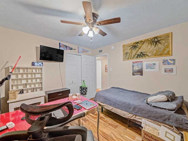 1824 Castille Dr, Carrollton, TX 75007 - bedroom with wood finished floors, a closet, and a ceiling fan