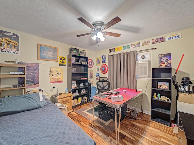 1824 Castille Dr, Carrollton, TX 75007 - bedroom featuring an office area, wood finished floors, a textured ceiling, and a ceiling fan