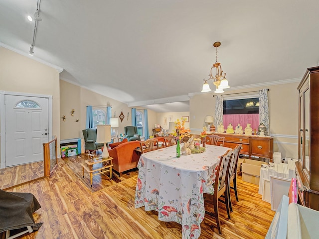 1824 Castille Dr, Carrollton, TX 75007 - dining room with light wood-type flooring, ornamental molding, track lighting, a chandelier, and vaulted ceiling