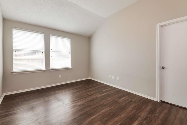 532 Chestnut Trl, Forney, TX 75126 - unfurnished room featuring dark wood finished floors, lofted ceiling, baseboards, and a textured ceiling