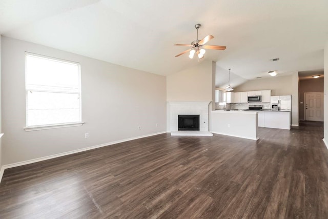 532 Chestnut Trl, Forney, TX 75126 - unfurnished living room with vaulted ceiling, a ceiling fan, a fireplace, dark wood-style flooring, and baseboards