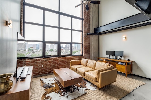 3110 Thomas Ave Unit 535, Dallas, TX 75204 - living room featuring brick wall, a ceiling fan, and a high ceiling