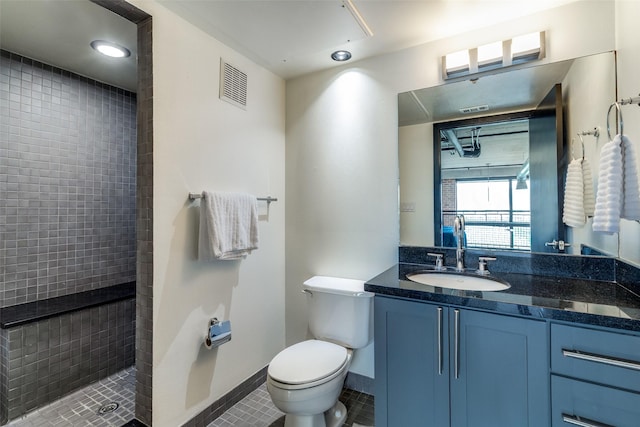 3110 Thomas Ave Unit 535, Dallas, TX 75204 - full bath featuring a tile shower, toilet, tile patterned flooring, vanity, and baseboards
