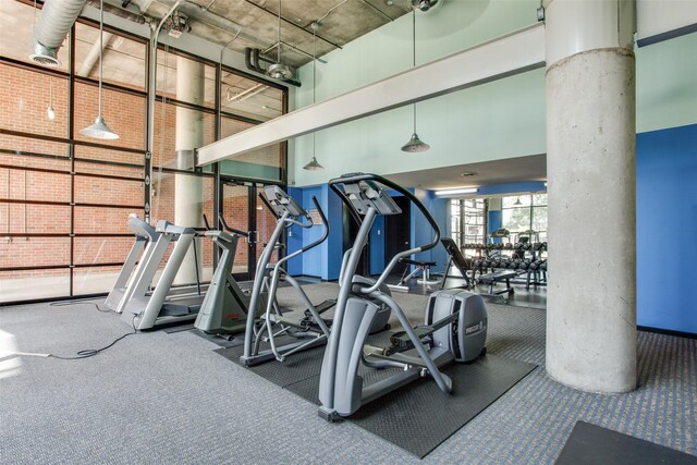 3110 Thomas Ave Unit 535, Dallas, TX 75204 - exercise room with decorative columns and carpet flooring