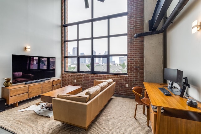 3110 Thomas Ave Unit 535, Dallas, TX 75204 - carpeted living area with brick wall, a desk, and a high ceiling