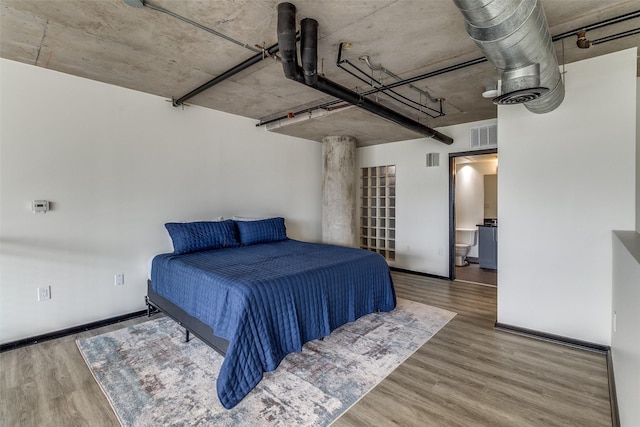 3110 Thomas Ave Unit 535, Dallas, TX 75204 - bedroom with wood finished floors and baseboards