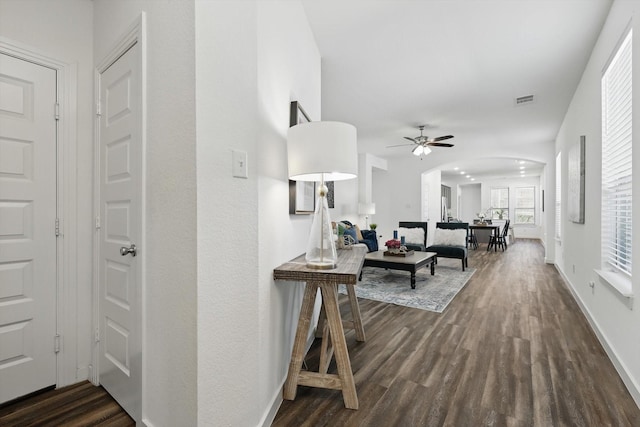 1012 Friesian Ln, Aubrey, TX 76227 - living room with dark wood-style flooring, a ceiling fan, baseboards, and arched walkways