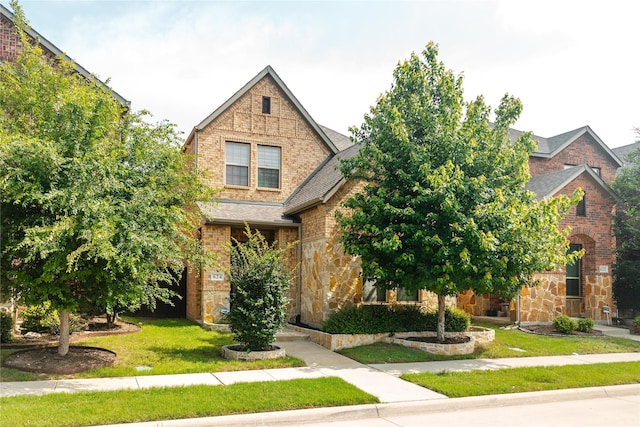 624 Ansley Way, Allen, TX 75013 - view of front facade featuring stone siding, a front lawn, roof with shingles, and brick siding