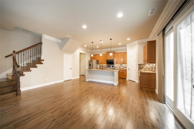 624 Ansley Way, Allen, TX 75013 - unfurnished living room featuring crown molding, stairs, healthy amount of natural light, dark wood finished floors, and recessed lighting