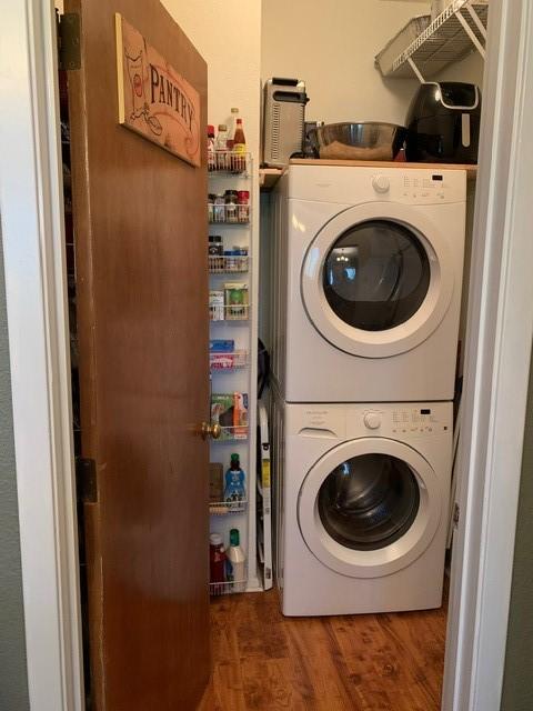 151 Summer Place Cir, Pottsboro, TX 75076 - laundry room with stacked washer and clothes dryer and wood finished floors
