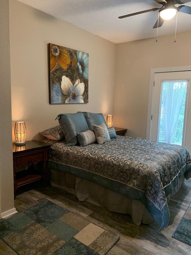 151 Summer Place Cir, Pottsboro, TX 75076 - bedroom with wood finished floors, a ceiling fan, and a textured ceiling