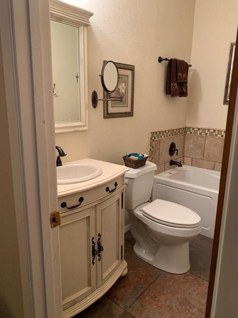 151 Summer Place Cir, Pottsboro, TX 75076 - bathroom featuring vanity, toilet, a garden tub, and tile patterned floors