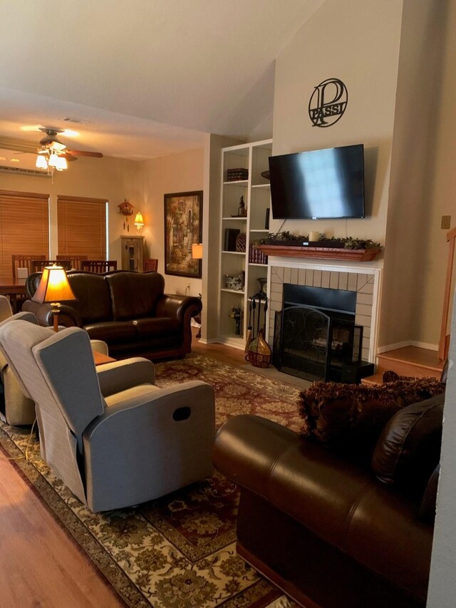 151 Summer Place Cir, Pottsboro, TX 75076 - living room with a tile fireplace, ceiling fan, wood finished floors, and lofted ceiling