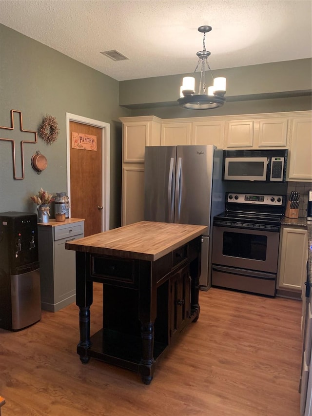 151 Summer Place Cir, Pottsboro, TX 75076 - kitchen featuring wooden counters, stainless steel range with electric stovetop, a chandelier, white cabinetry, and light wood finished floors