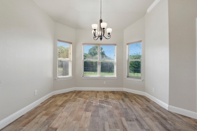 2304 Forest Hill Ln, Granbury, TX 76048 - unfurnished room featuring wood finished floors, a chandelier, and baseboards