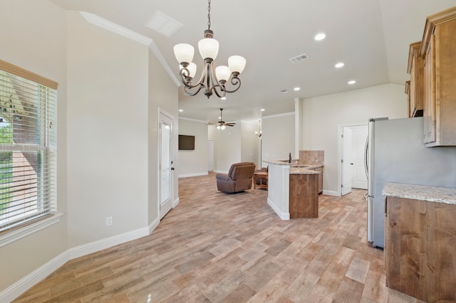 2304 Forest Hill Ln, Granbury, TX 76048 - kitchen with open floor plan, freestanding refrigerator, a chandelier, plenty of natural light, and recessed lighting